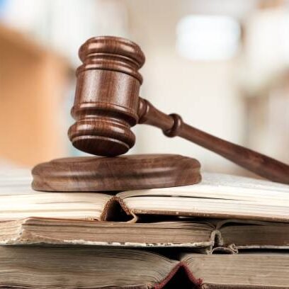 Wooden judge gavel with books, law and justice concept